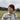 man in burgundy beanie hat outdoors.